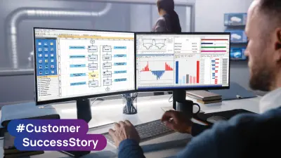 Person working at a dual-monitor workstation displaying ETAS software dashboards and workflow diagrams with customer success story branding.