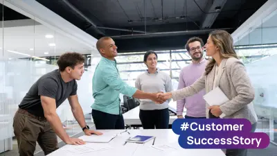 Four people are smiling, and two are holding hands.