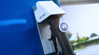 Hydrogen fueling nozzle marked H₂ inserted into a 350-bar hydrogen refueling station connector.