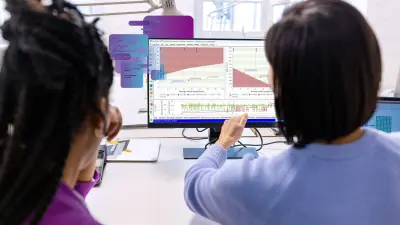 Two calibration engineers in front of a computer working with ETAS software