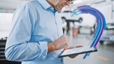 Workshop employee using automotive diagnostics hardware