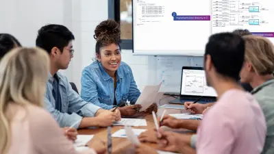 Team sits around a table and discusses