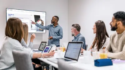 people are sitting in the AUTOSAR sequrity training course. And the instructor shows something on the flat screen