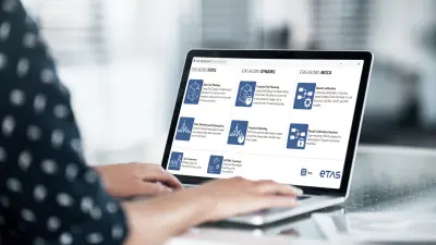 Image of a laptop with an ETAS ASCMO user interface on the screen showing various graphics and diagrams.